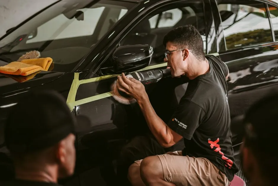 professional car detailer working through car detailing methods on a vehicle