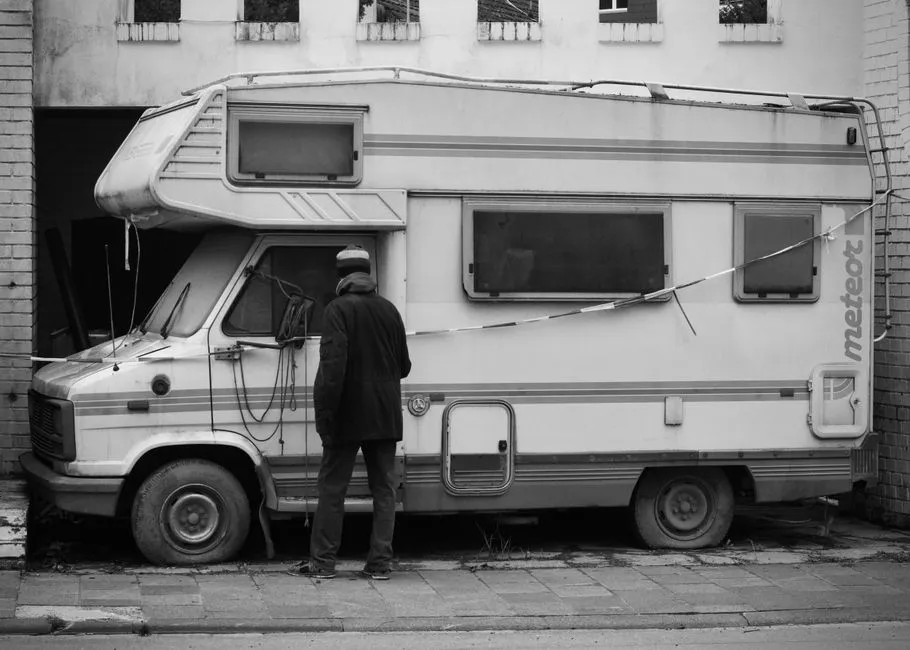 detailer washing the exterior panels of a large caravan
