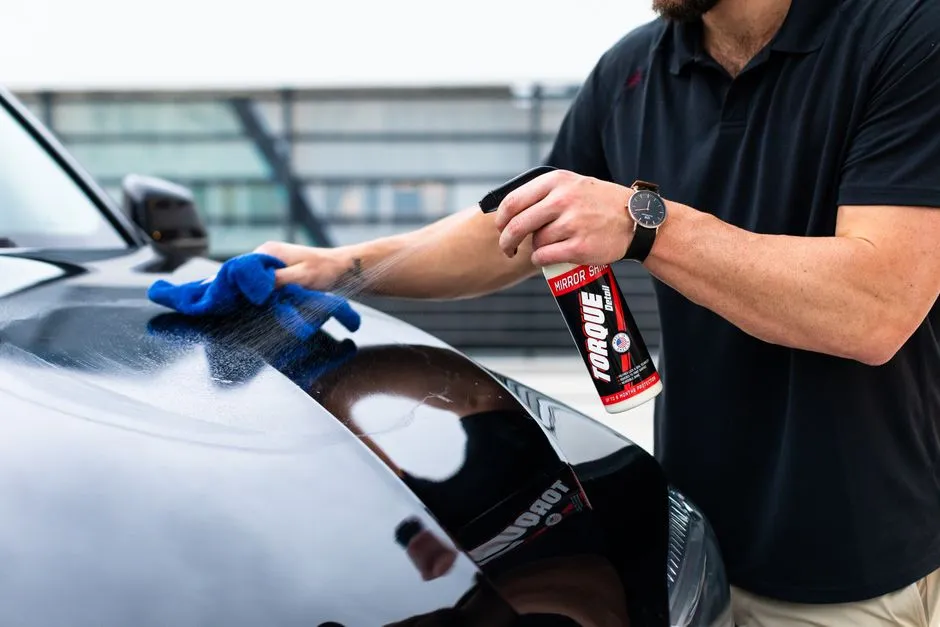 spray bottle and microfibre cloth used to remove water spots from car paint at home