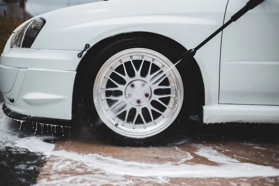 underbody and wheel well of a car being pressure washed to flush salt and silt after wet season