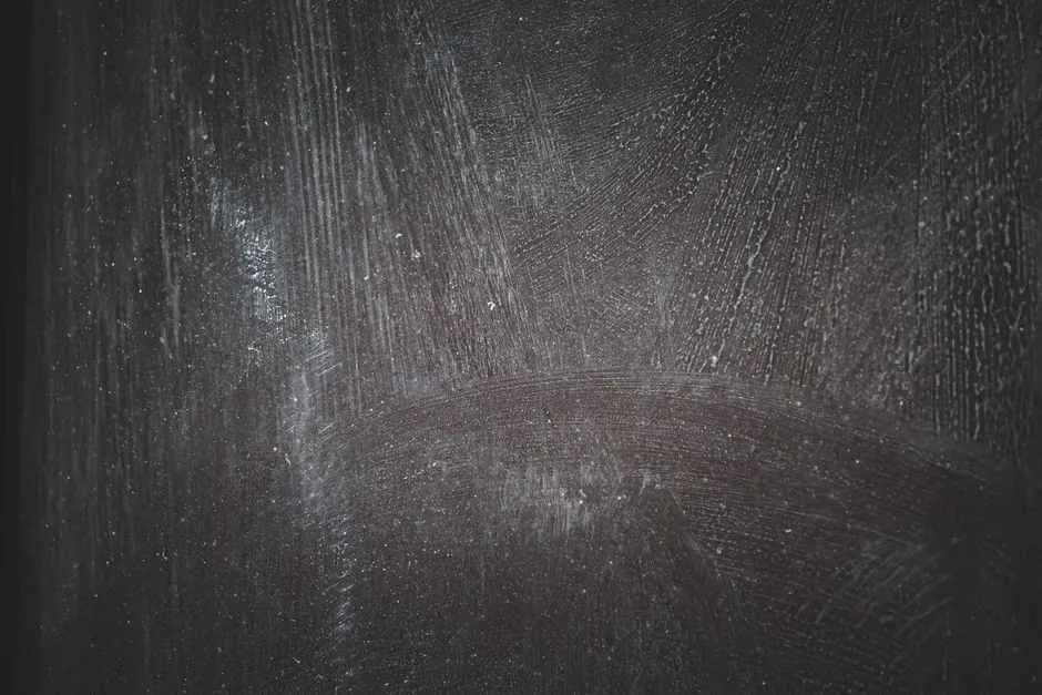 swirl marks and fine scratches on dark car paint from an automatic car wash